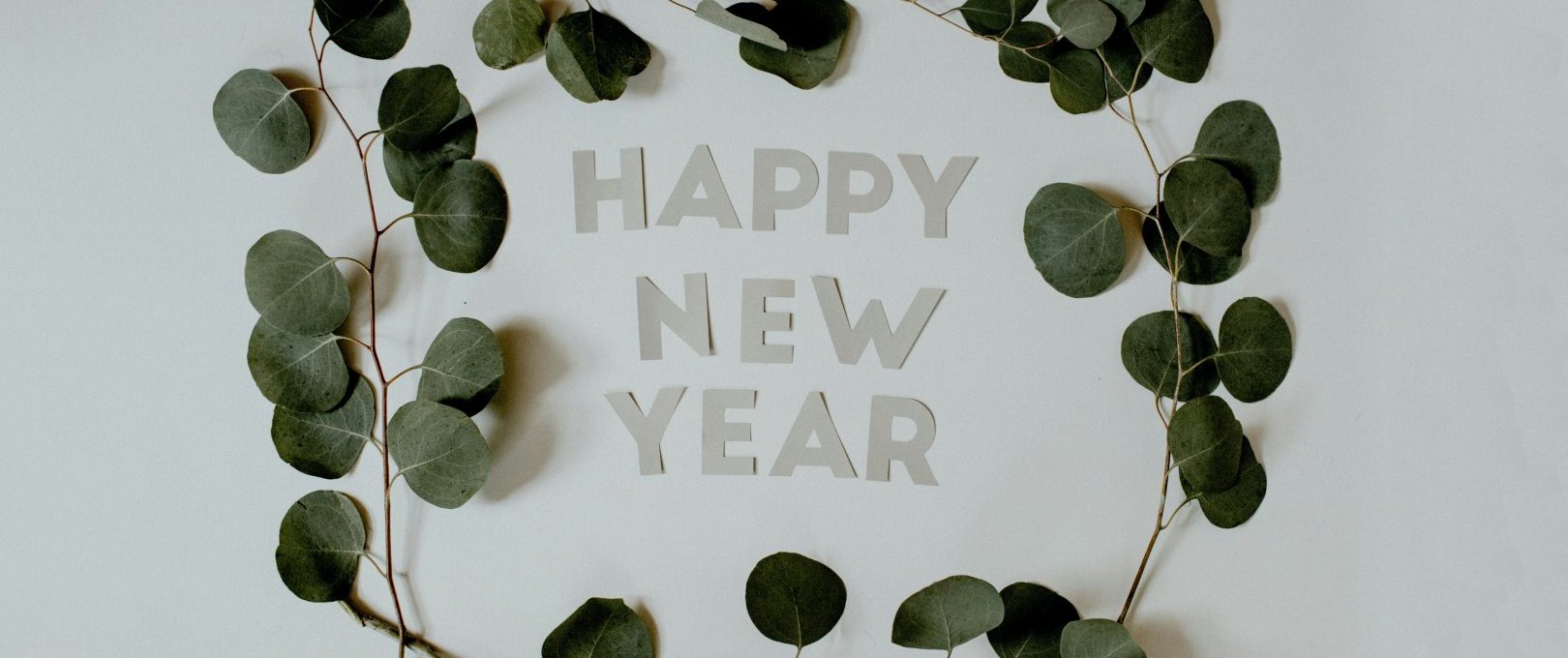 happy new year greeting card with eucalyptus leaves at The  Kace